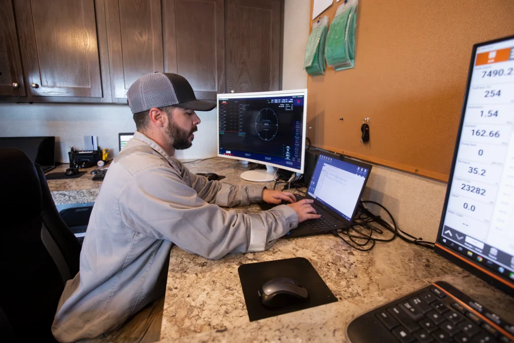 ProDirectional technician performing remote MWD monitoring and directional drilling data analysis from a field office.