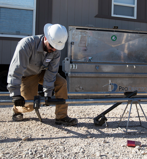 Field technician preparing high-temperature Octane MWD tool for downhole deployment at the wellsite