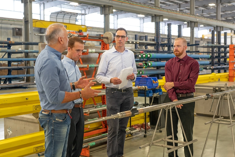 ProDirectional engineers and management reviewing proprietary downhole drilling tools in the Texas manufacturing facility